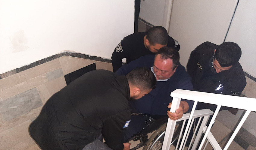 פקחי העירייה נושאים את אלכסנדר דריתר לביתו (צילום: דוברות עיריית חיפה)