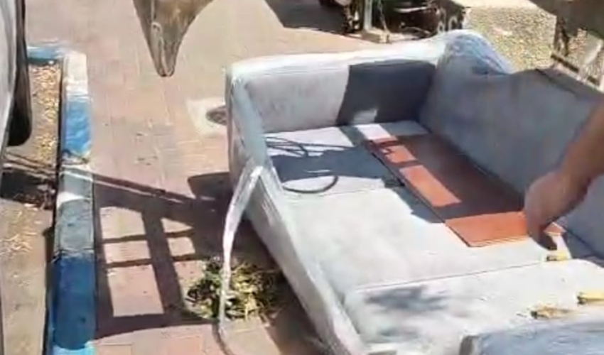 הספה ההרוסה אחרי שהורדה מהמשאית (צילום: בארי הולצמן)